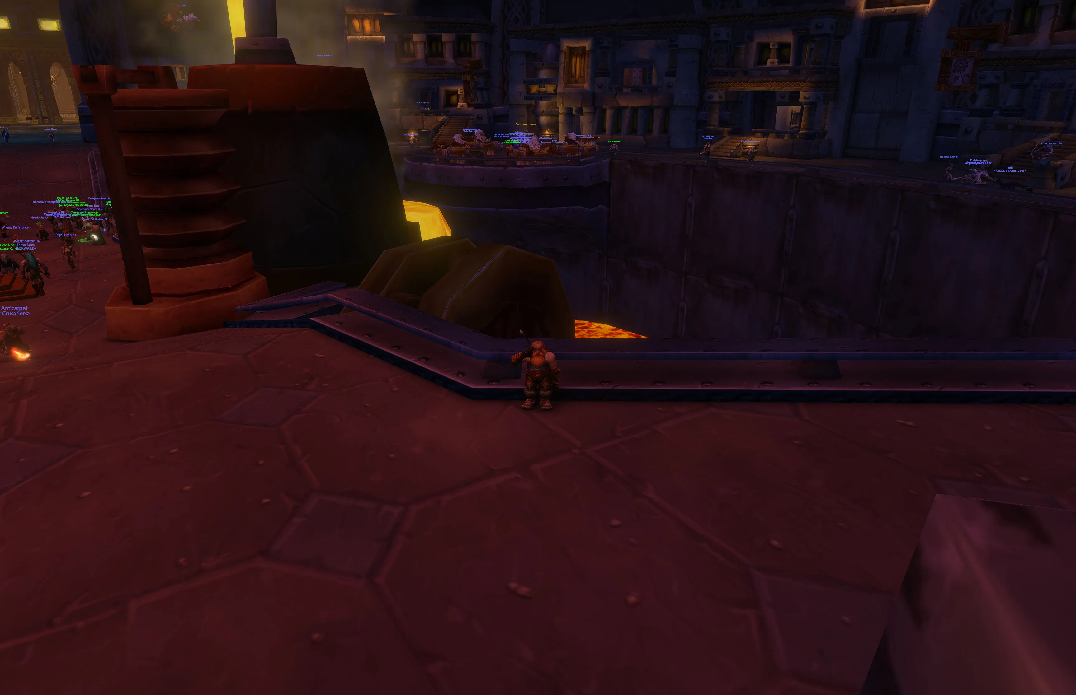 Nuir facing the camera with his hand raised in salute beside the Great Forge in Ironforge.